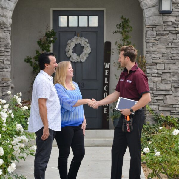 A Morrison Plus inspector greeting clients at a home